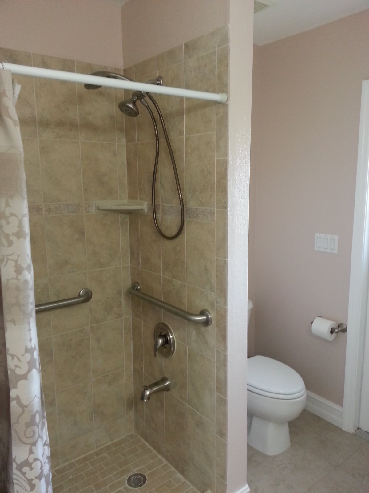 An accessible bathroom with a shower and toilet.