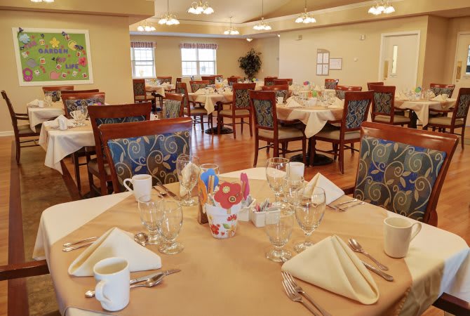 A well-arranged dining area with neatly set tables and chairs.