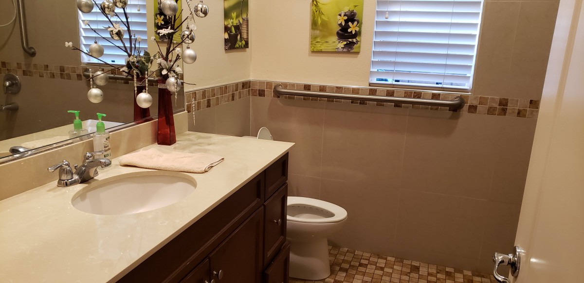 A neatly arranged bathroom with a countertop, sink, and toilet.