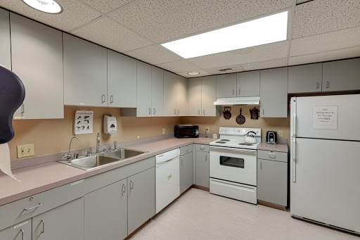 A modern kitchen equipped with essential appliances and ample storage.