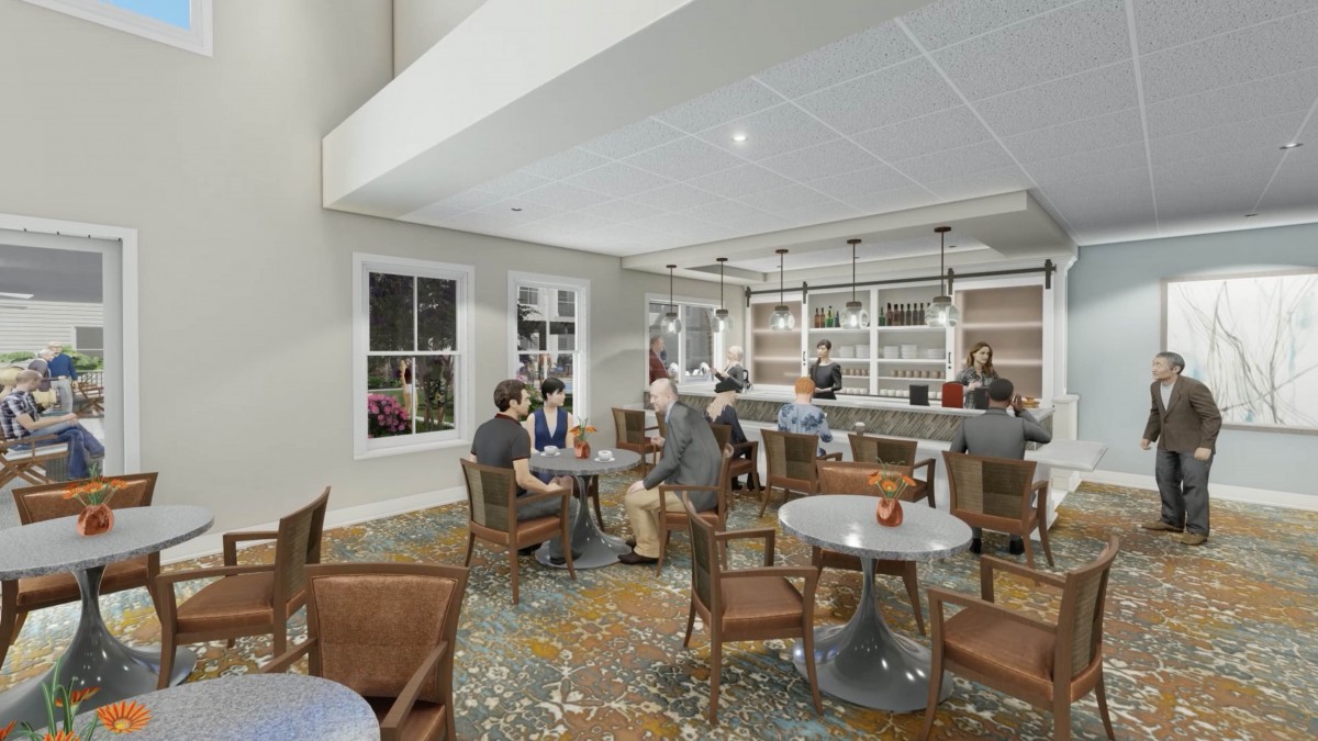 A modern cafe interior with people seated at tables and a bar counter.