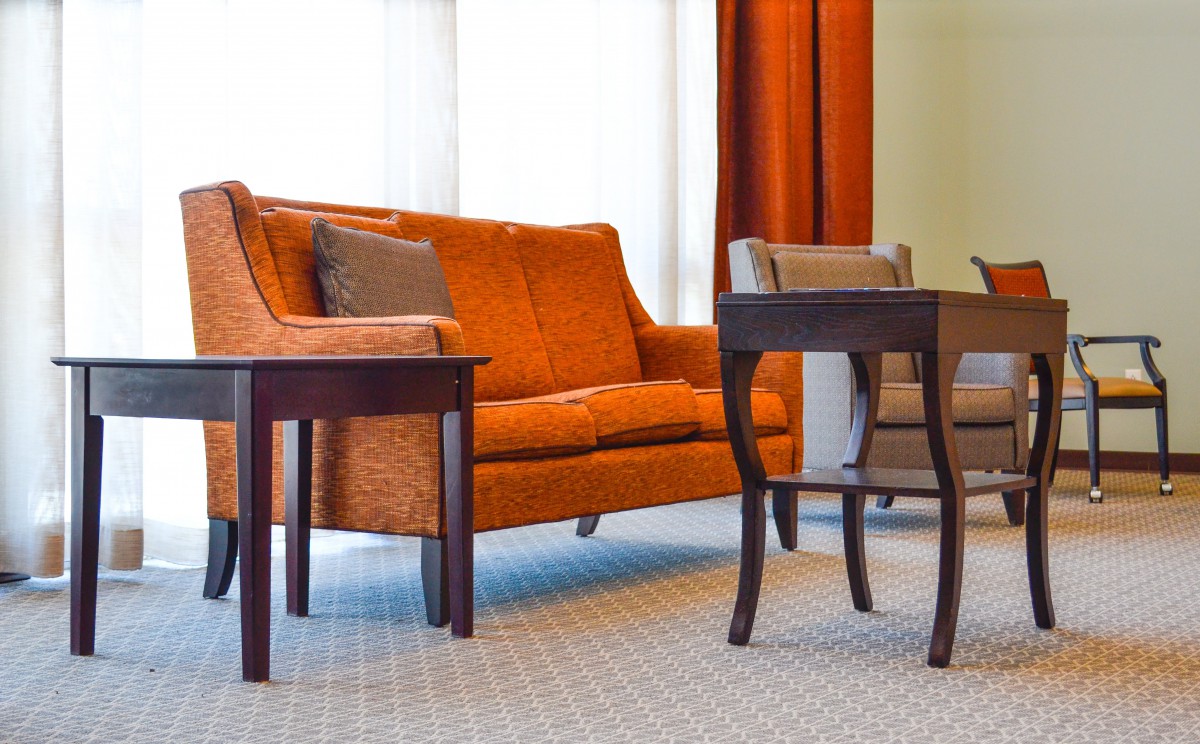 A cozy living room with an orange sofa and wooden coffee table.