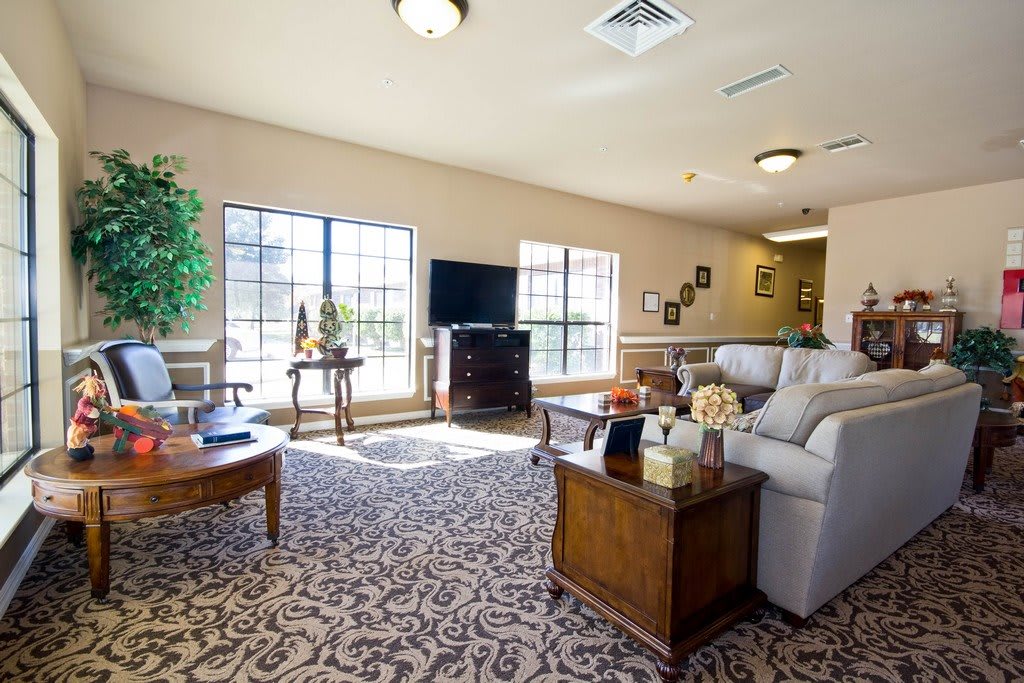 A well-lit living room with comfortable furniture and elegant decor.