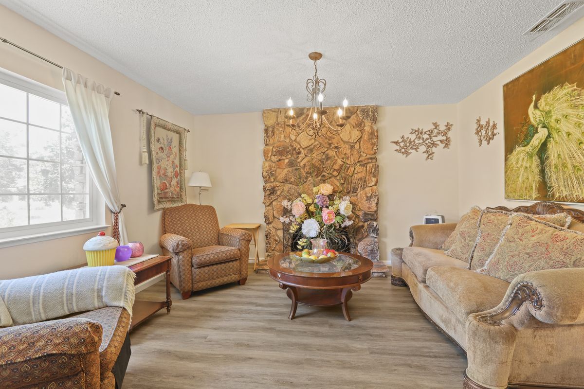 A cozy living room with classic furniture and floral decorations.