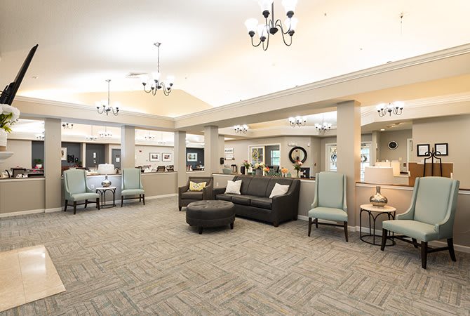 A spacious and elegantly decorated lobby with comfortable seating and chandeliers.