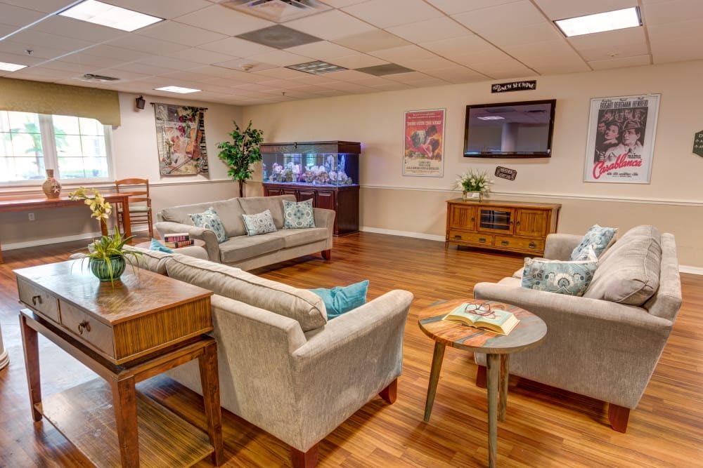 A comfortable and modern living room with sofas, a TV, and wooden flooring.