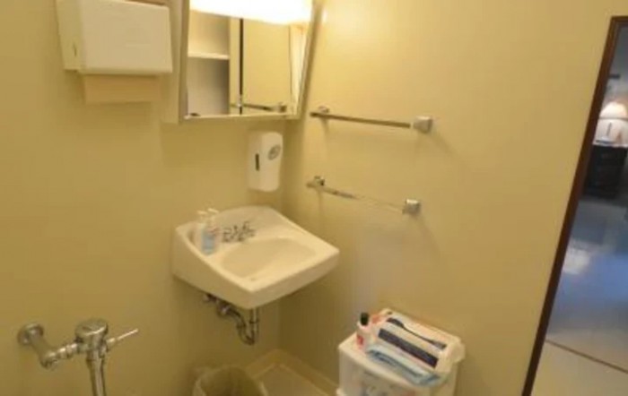 A small, neatly organized bathroom with a sink and mirror.