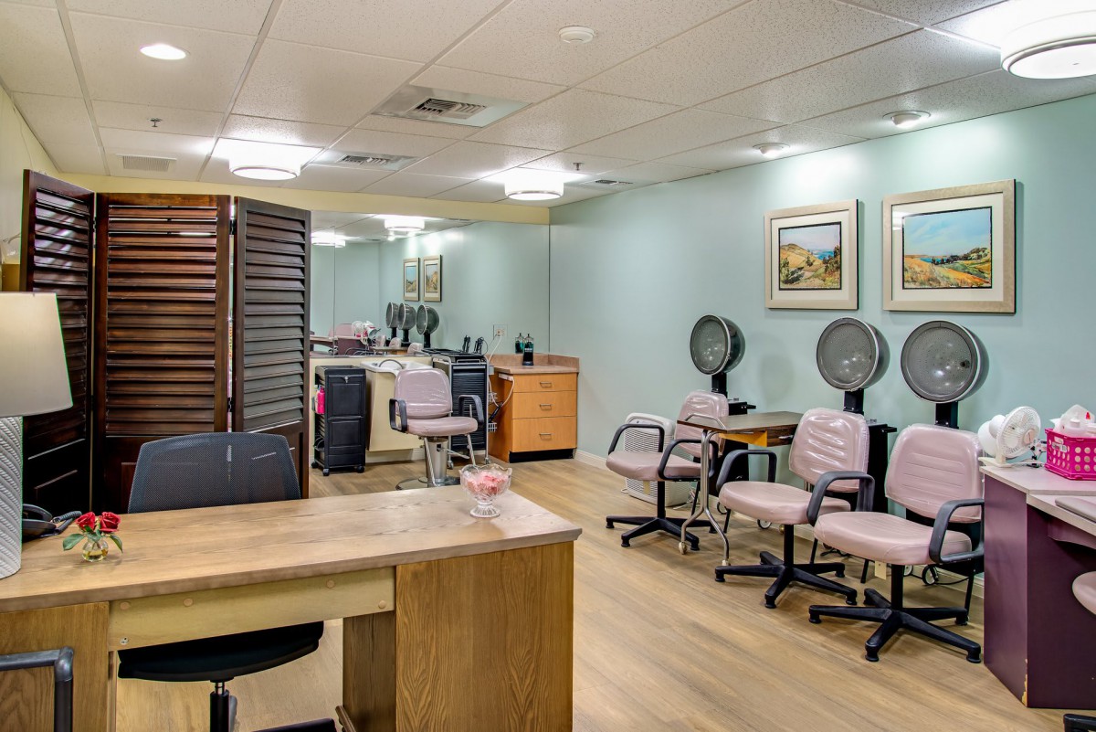 A cozy salon interior with chairs, mirrors, and hair dryers.