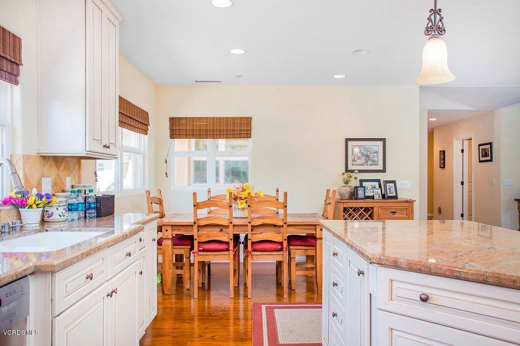 A cozy kitchen and dining area featuring wooden furniture and bright natural lighting.