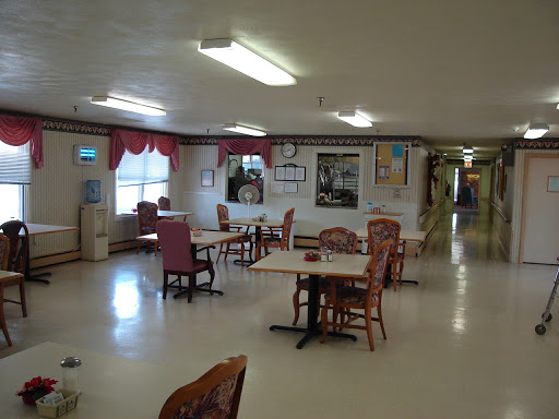 A spacious dining area featuring tables and chairs, designed for communal gatherings.