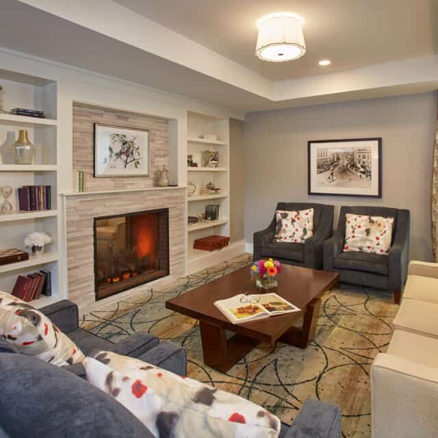 A cozy living room featuring a warm fireplace, comfortable seating, and elegant interior design.