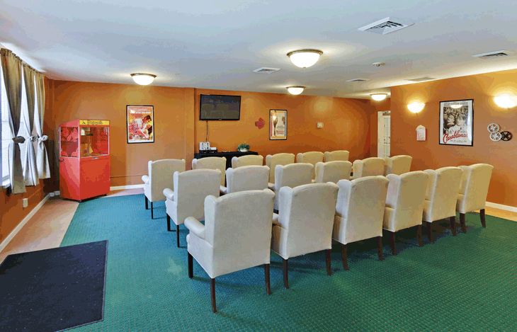 A conference room set up with theater-style seating arranged for a presentation or meeting.