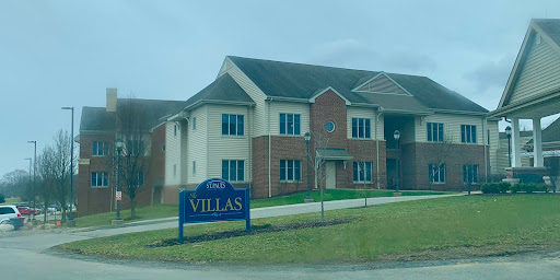 A residential building showcasing the 'Villas' sign, indicating apartments for rent or lease.