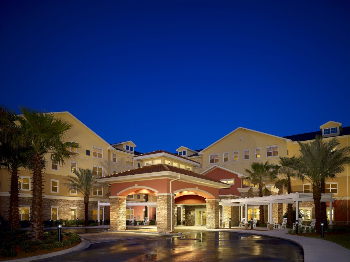 Elegant hotel entrance illuminated at night.