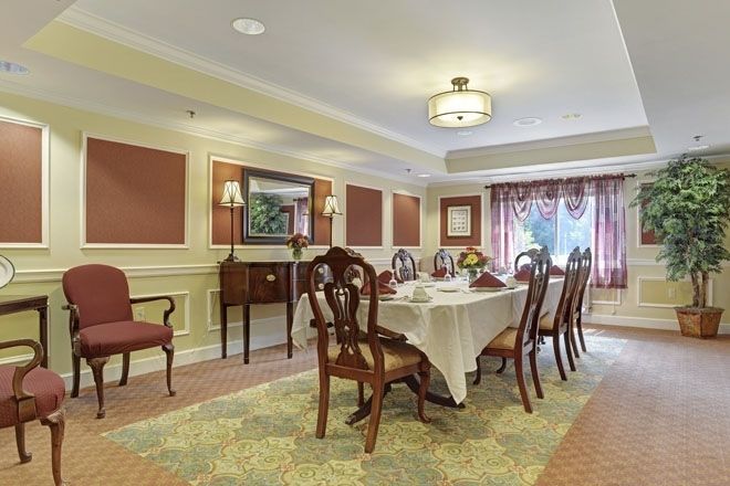 A beautifully decorated dining room with an elegant table setting and classic furnishings.