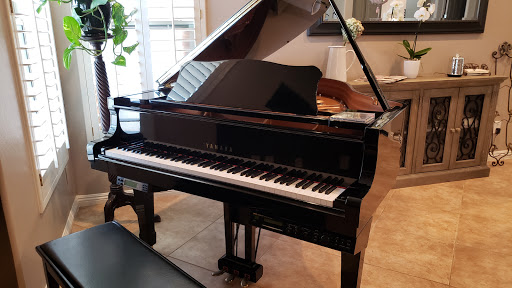 A beautifully polished grand piano set in a cozy indoor space.