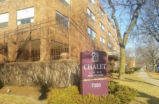 The Chalet apartment building with a welcoming sign.