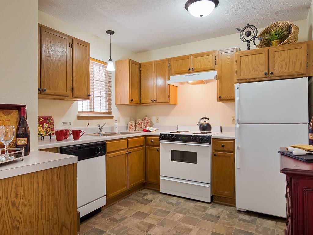A cozy kitchen with wooden cabinets and modern appliances.