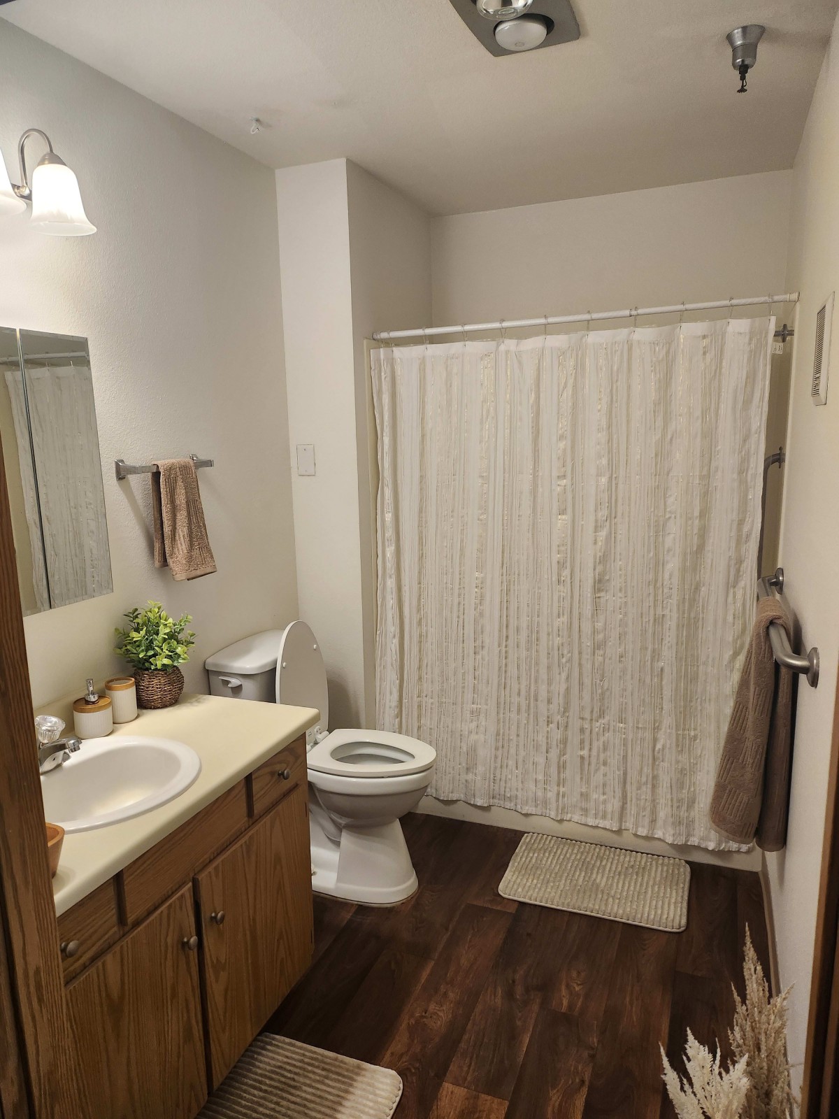 A clean and tidy bathroom with essential amenities including a sink, toilet, and shower.