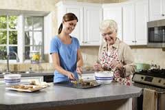 Two women enjoy baking together in the kitchen.