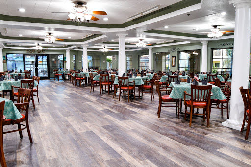 A spacious dining area featuring wooden tables and chairs, designed for a comfortable dining experience.