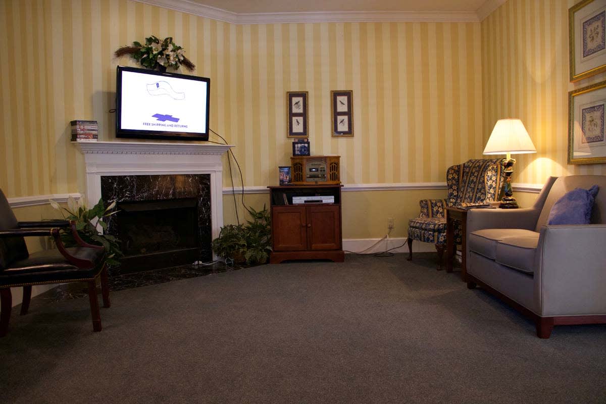 A cozy living room with a fireplace, television, and comfortable seating.
