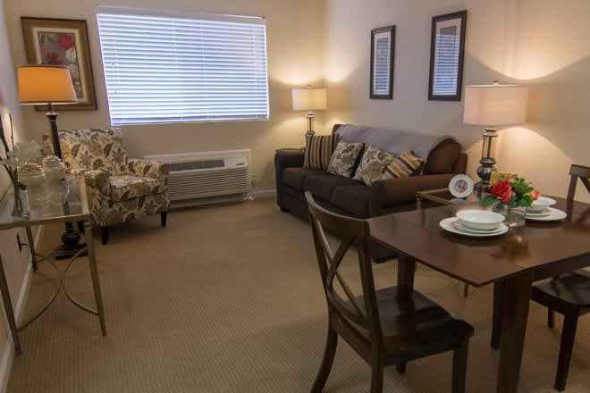 A cozy living room with comfortable seating and warm lighting.