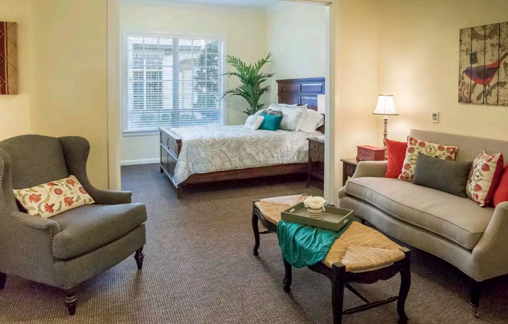 A cozy bedroom with ample natural light and comfortable seating area.