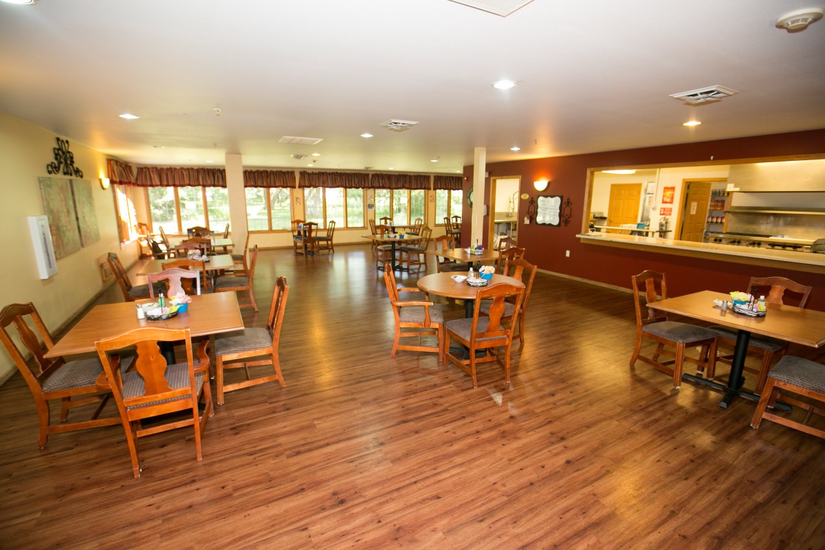Spacious dining area with wooden floors and ample lighting.