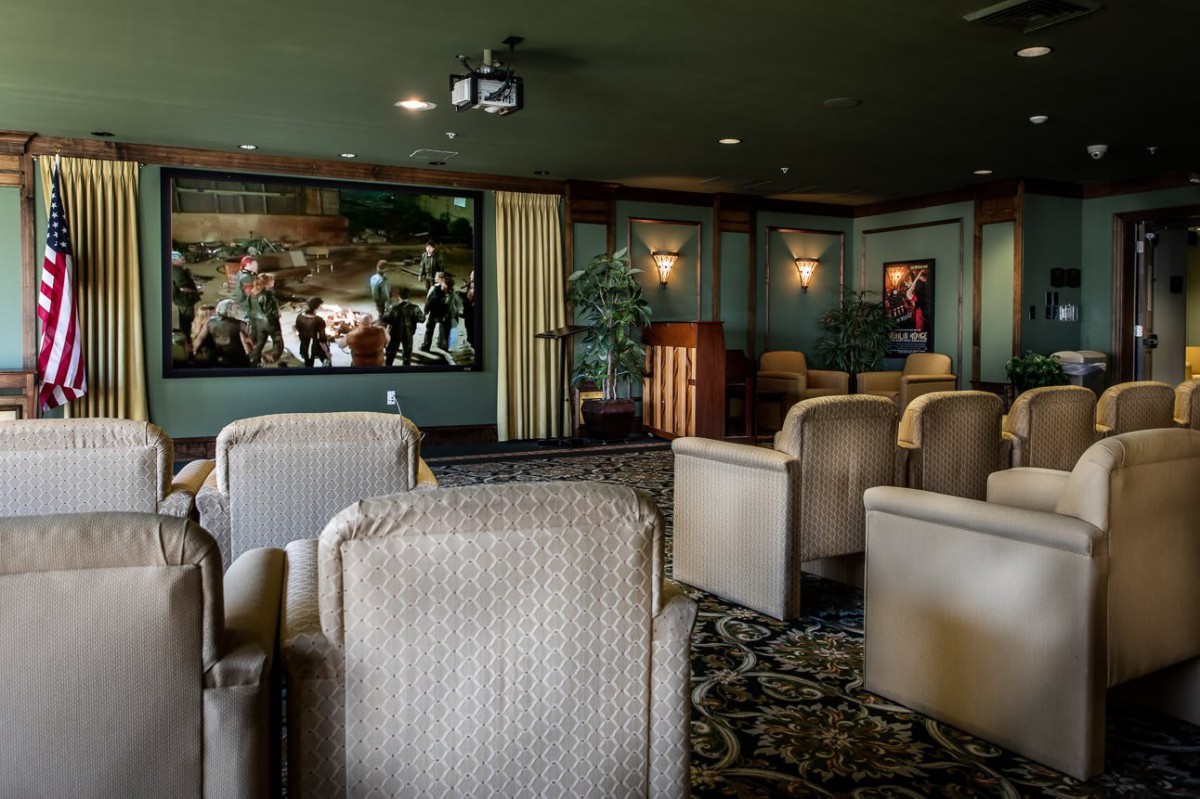 Cozy theater room with comfortable seating and a projector.