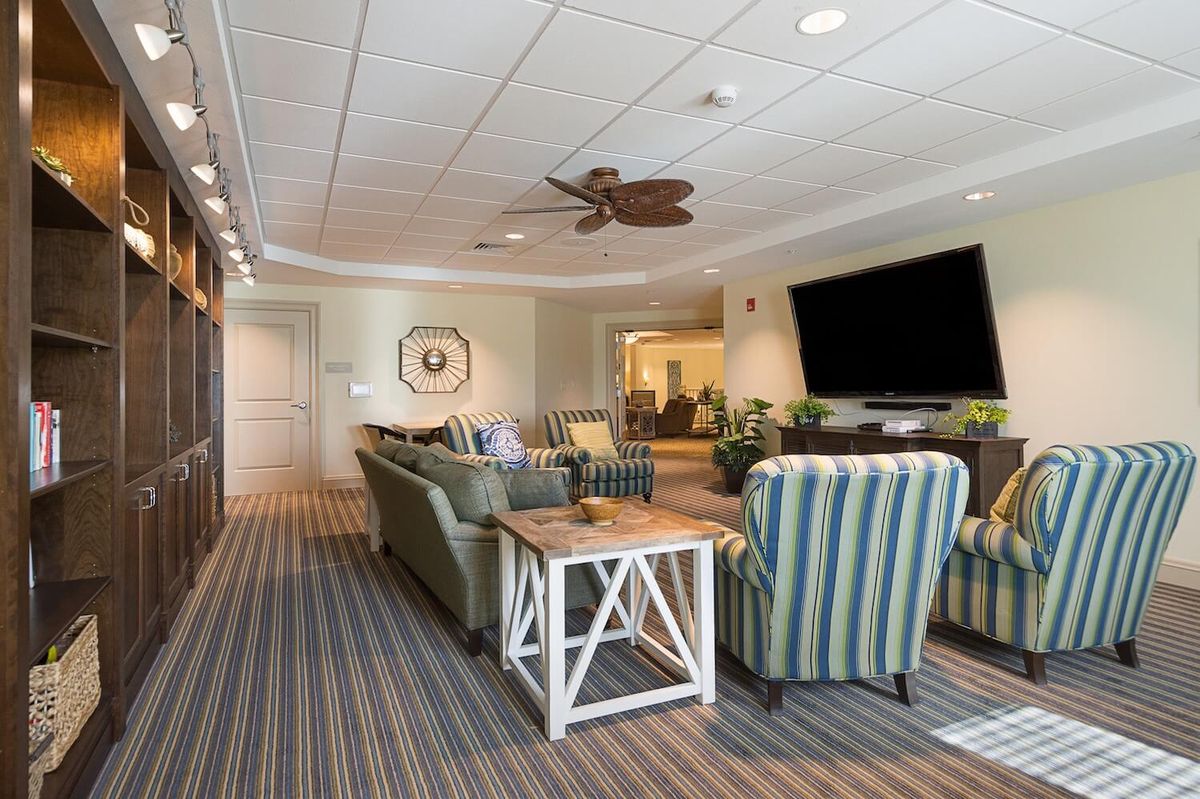 A cozy living room with comfortable seating and a large television.