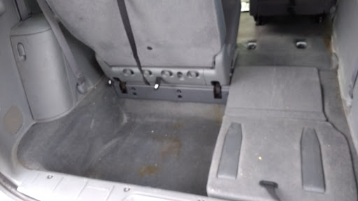 A view of the rear interior of a vehicle showcasing the floor space and seat configuration.