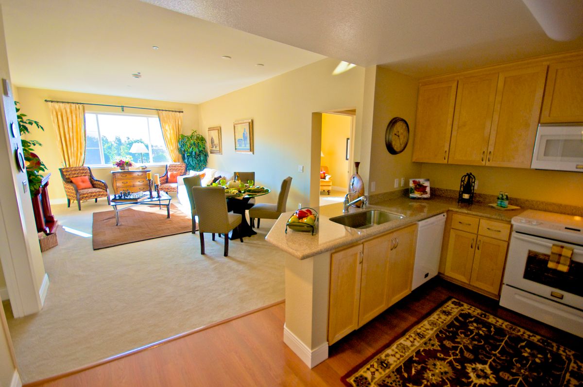 A spacious open floor plan featuring a kitchen and dining area with abundant natural light.