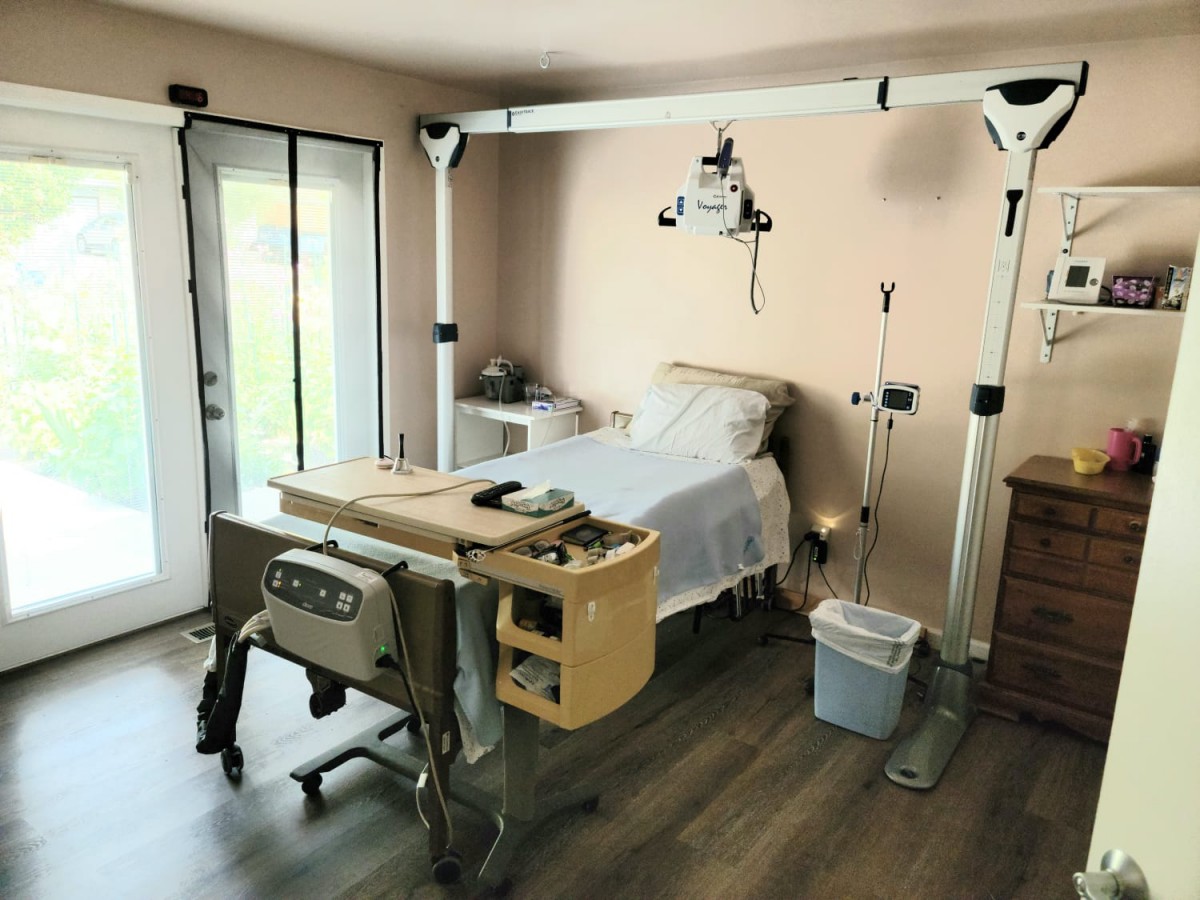 A clean and modern hospital room with medical equipment and a patient bed.