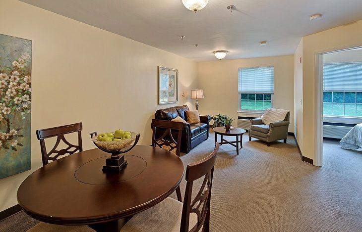 A cozy living and dining area with warm lighting and comfortable furniture.