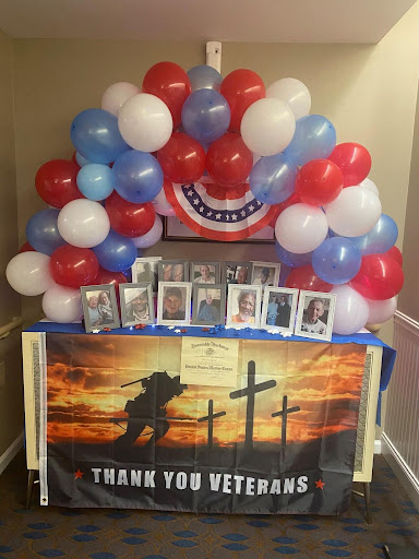 A heartfelt tribute to veterans, featuring a decorative setup with balloons and photos.