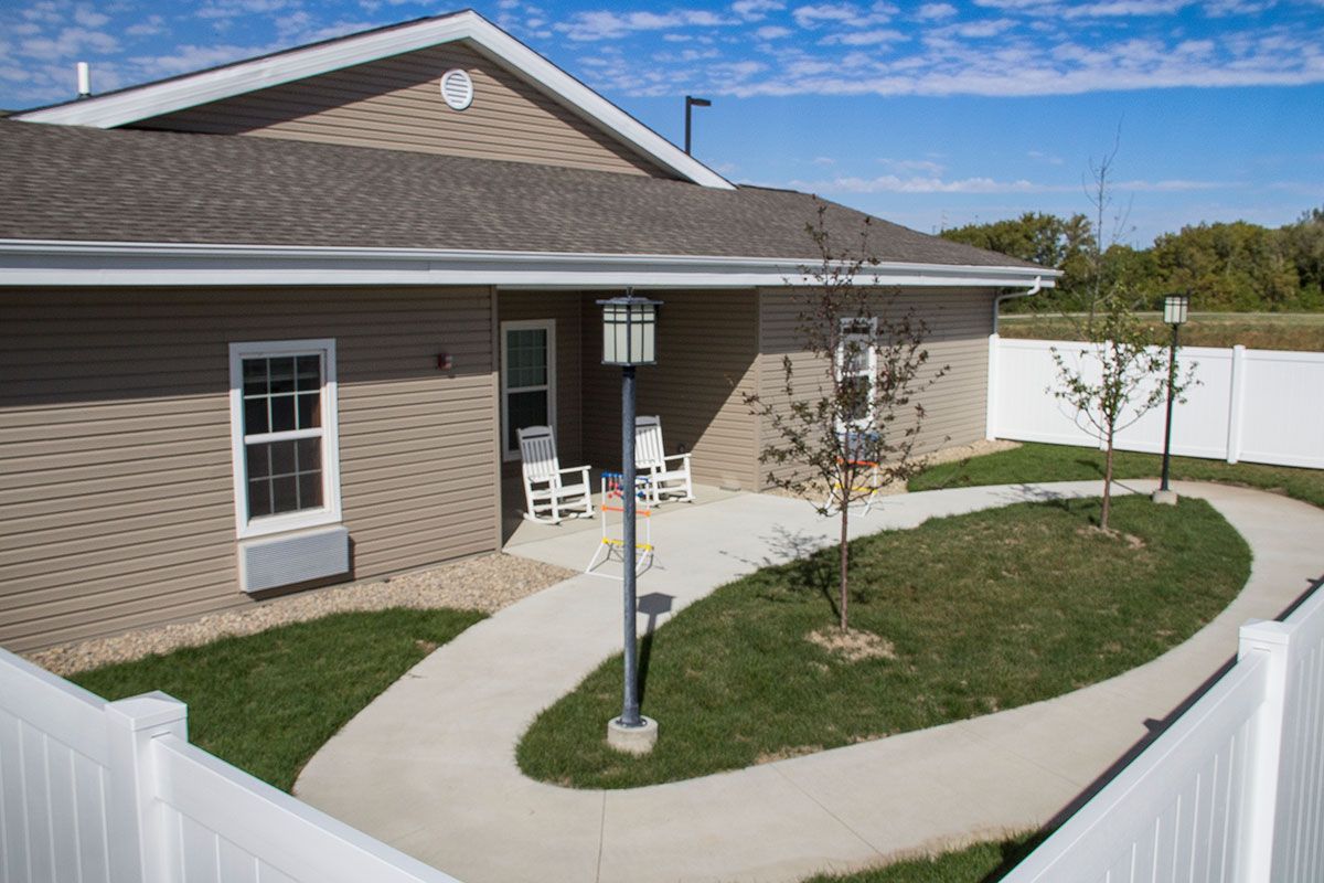 A single-story house with a curved pathway and small lawn area.