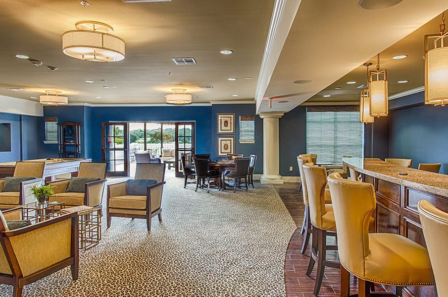 A modern lounge area with comfortable seating and a bar.