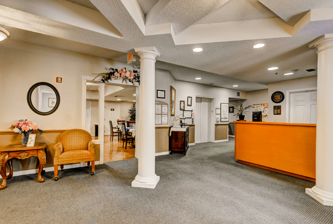A spacious lobby with a reception desk, seating area, and decorative elements.