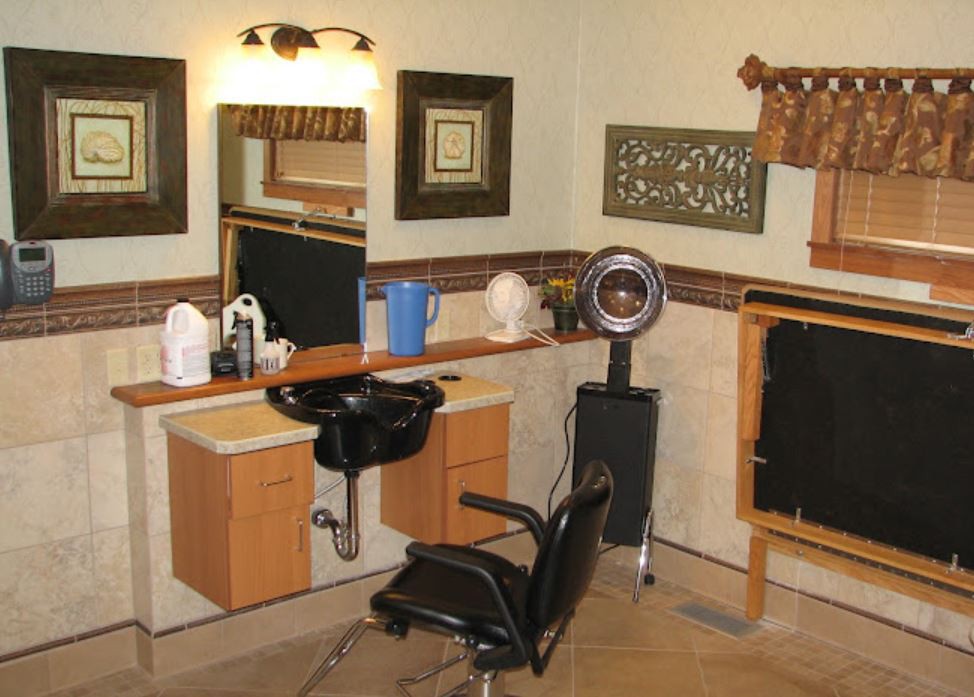 An interior view of a hairdressing salon with styling chairs and mirrors.