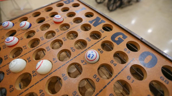 A close-up view of a bingo board with numbered balls in place.
