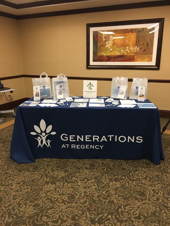 An informational booth for Generations at Regency featuring promotional materials.