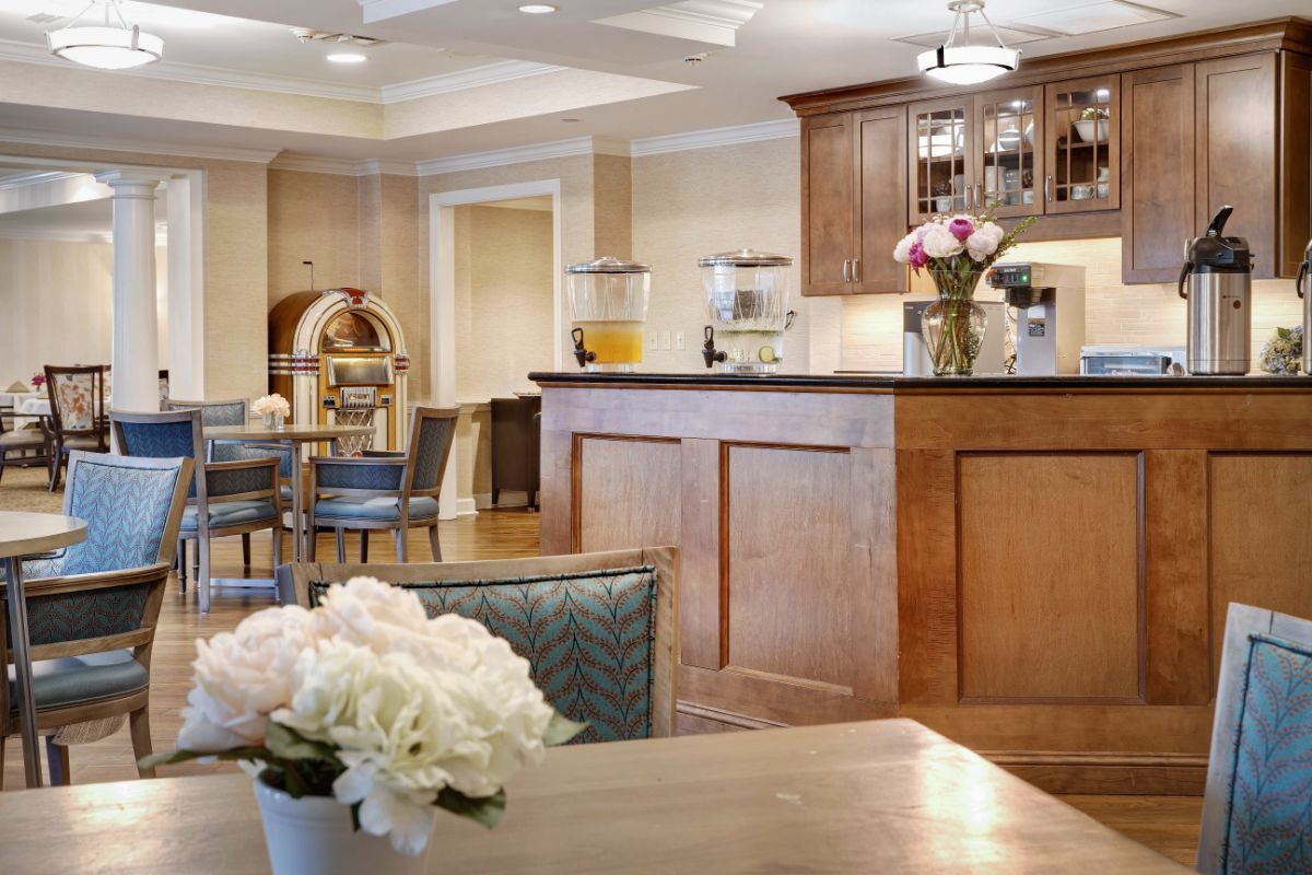 A cozy cafe interior with wooden furniture and floral decorations.