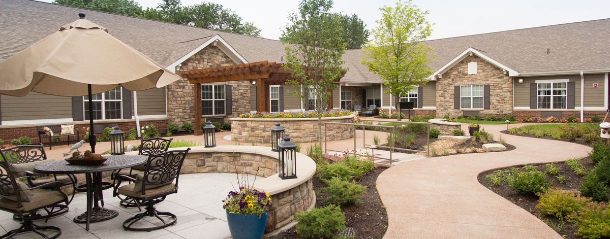 A beautifully landscaped residential garden with stone walls and pathways.