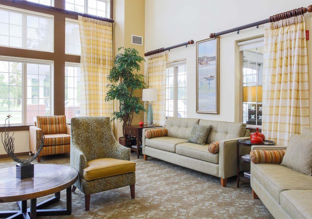 A cozy and well-decorated living room with comfortable seating and natural light.