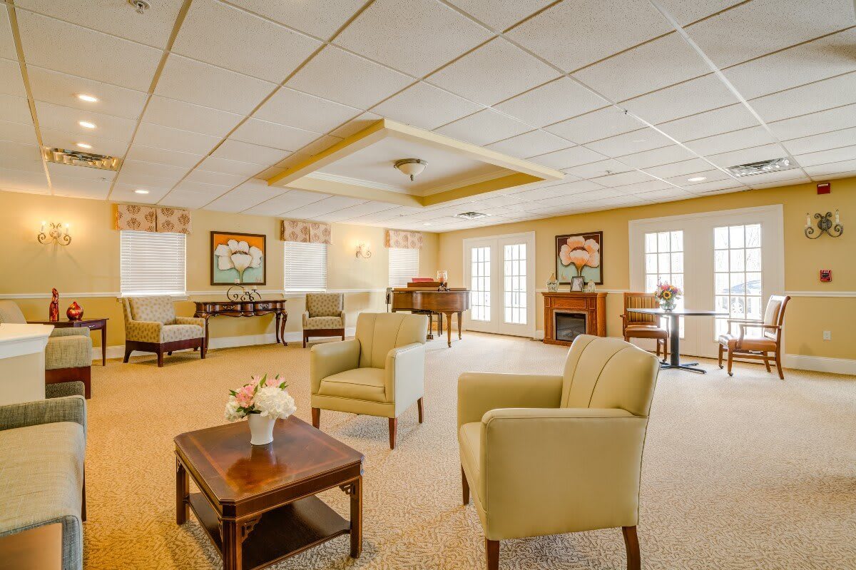 A spacious living room with comfortable chairs and elegant decor.