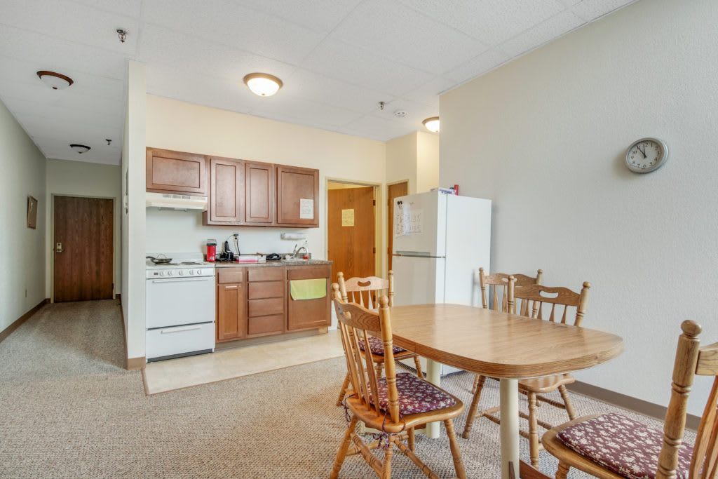 Cozy apartment kitchen and dining area with wooden furniture.