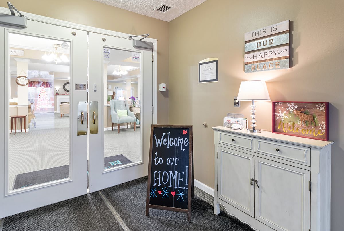 A cozy entrance with a 'Welcome to our home' sign and inviting decor.