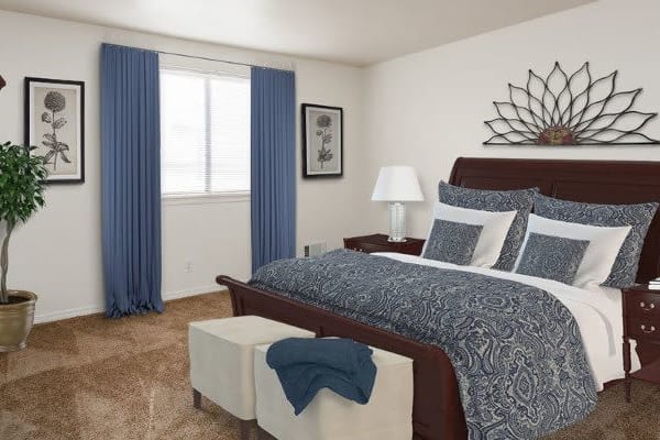 A cozy bedroom with blue accents and elegant decor.