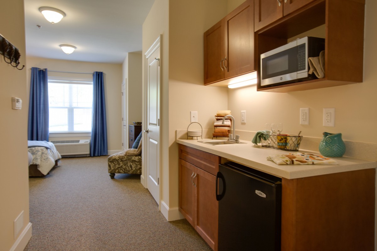 A compact kitchenette with a microwave and mini refrigerator in a modern apartment.